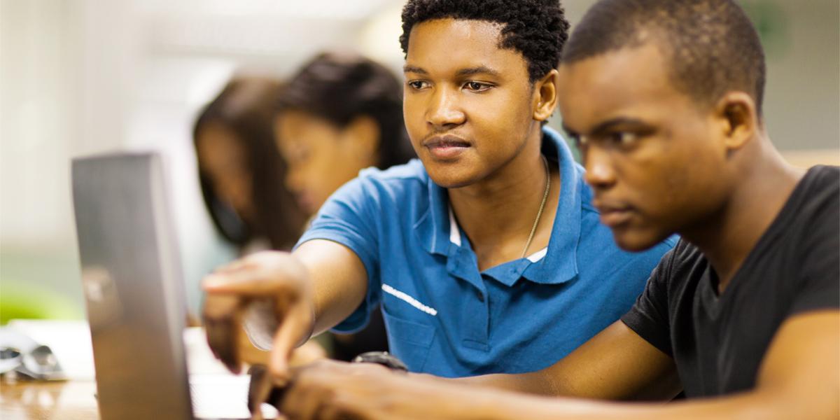 male students working at computer